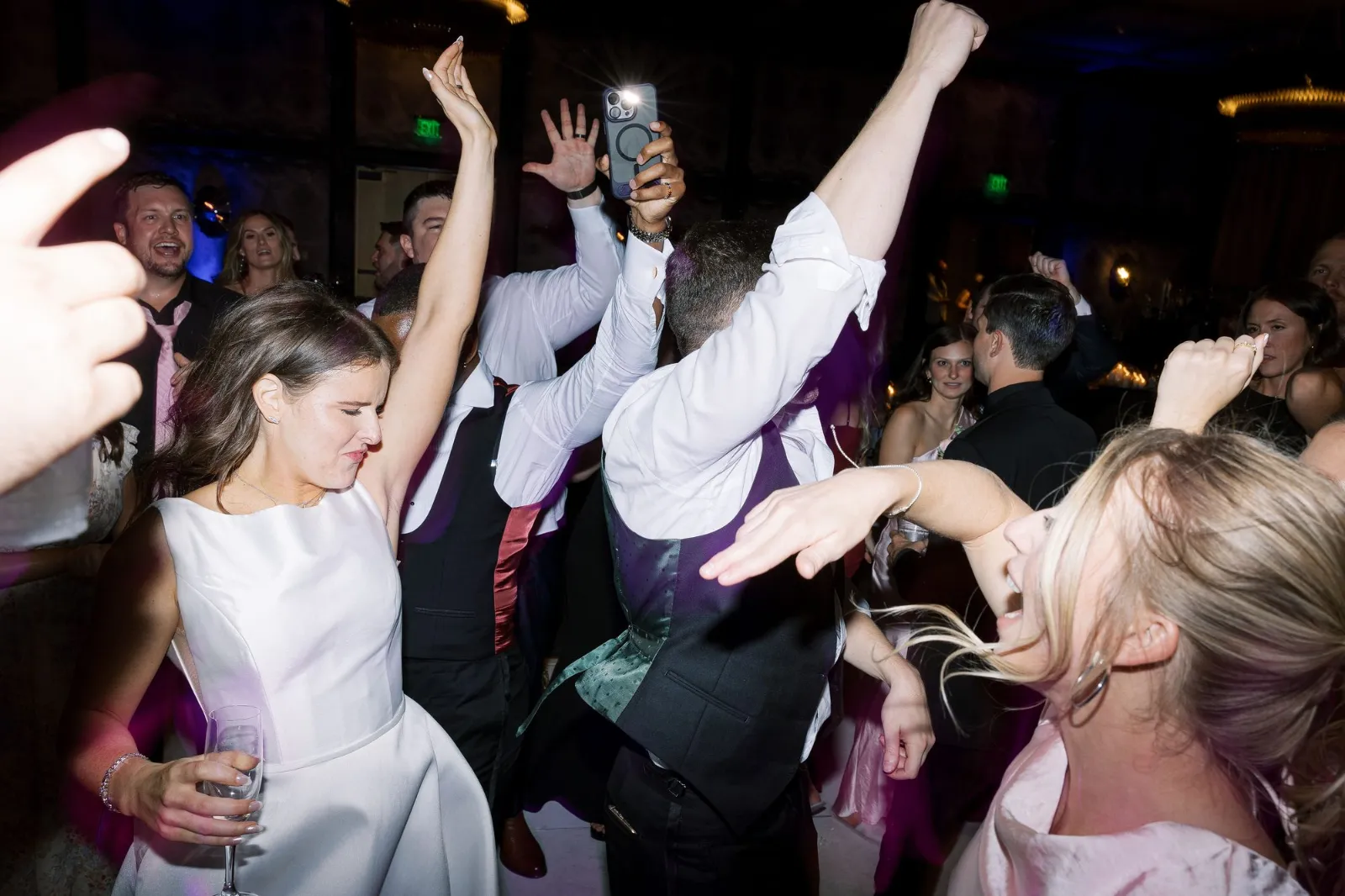 Couple dancing with guests celebrating