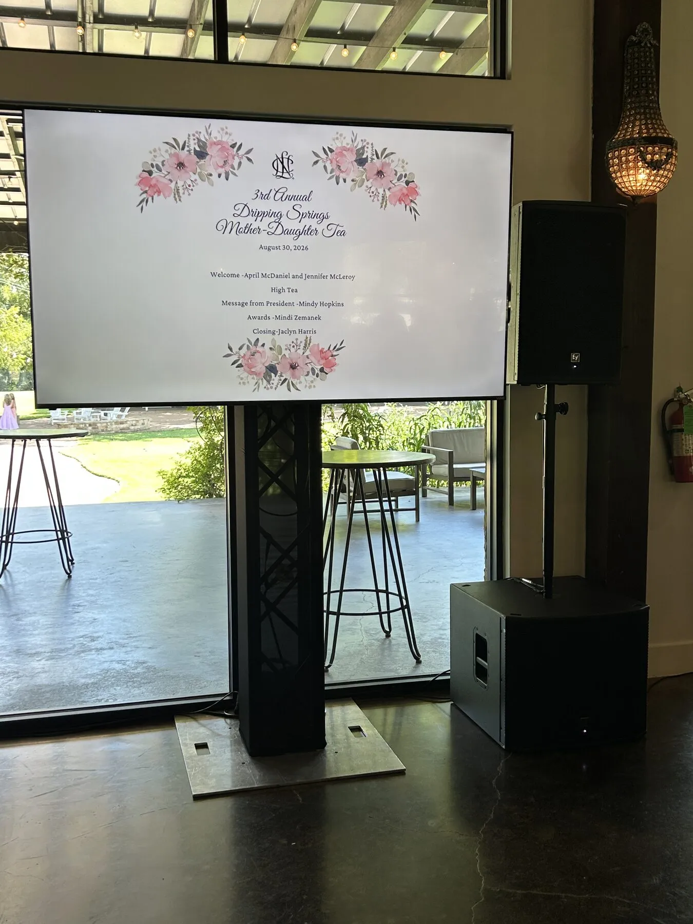 Display and column speaker on truss stands at a corporate event