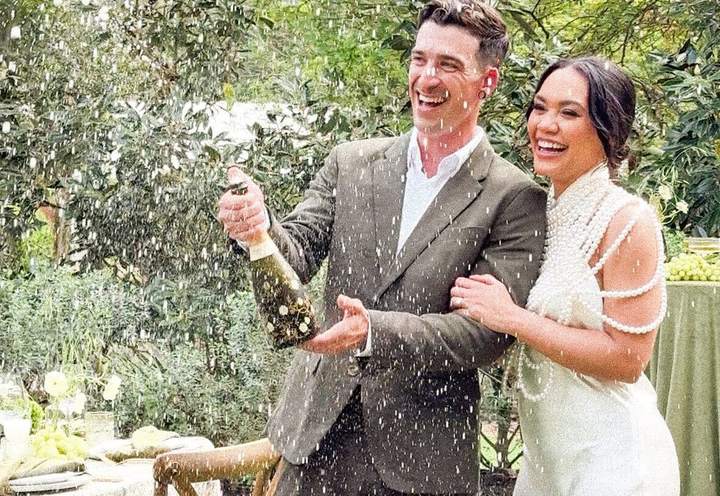 Newlyweds popping champagne, from Content by Clarice