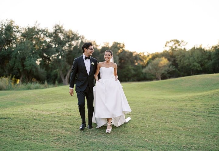 Couple walking across a lawn at sunset, by Diana Brewer Photography