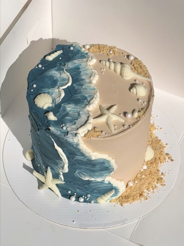Beach cake with buttercream waves, sand and white chocolate shells