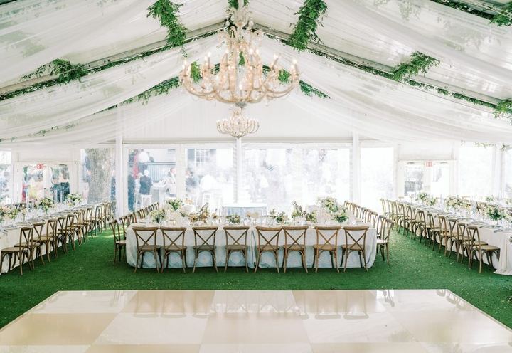 White tent with a chandelier and dance floor from Premiere Events