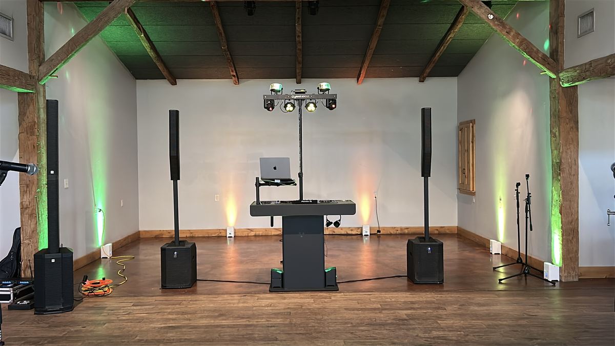 DJ setup at the end of the timber-beamed hall at Camp Lucy