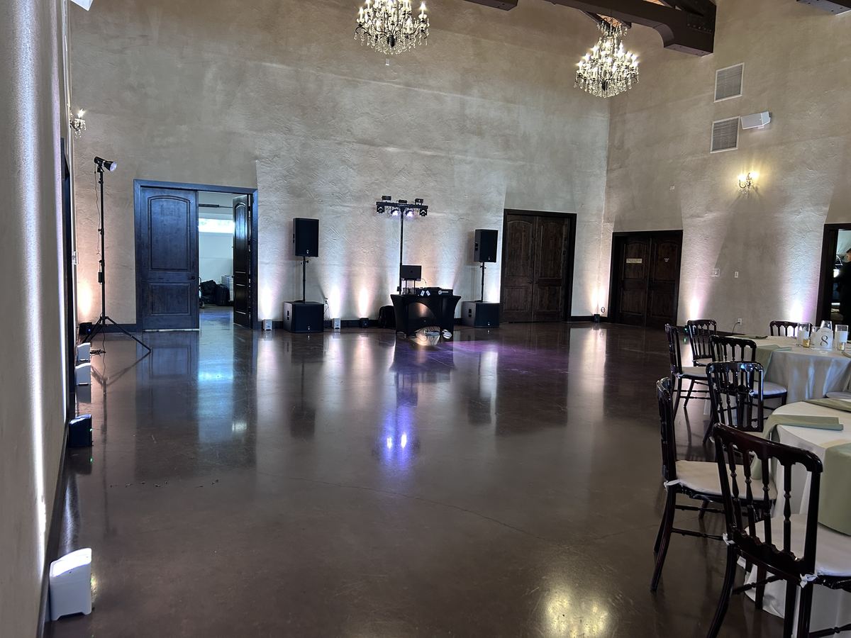 The main hall at Ma Maison with chandeliers and our setup on the far wall