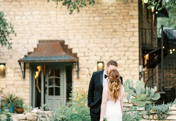 Couple in the garden in front of the stone house at Stonehouse Villa